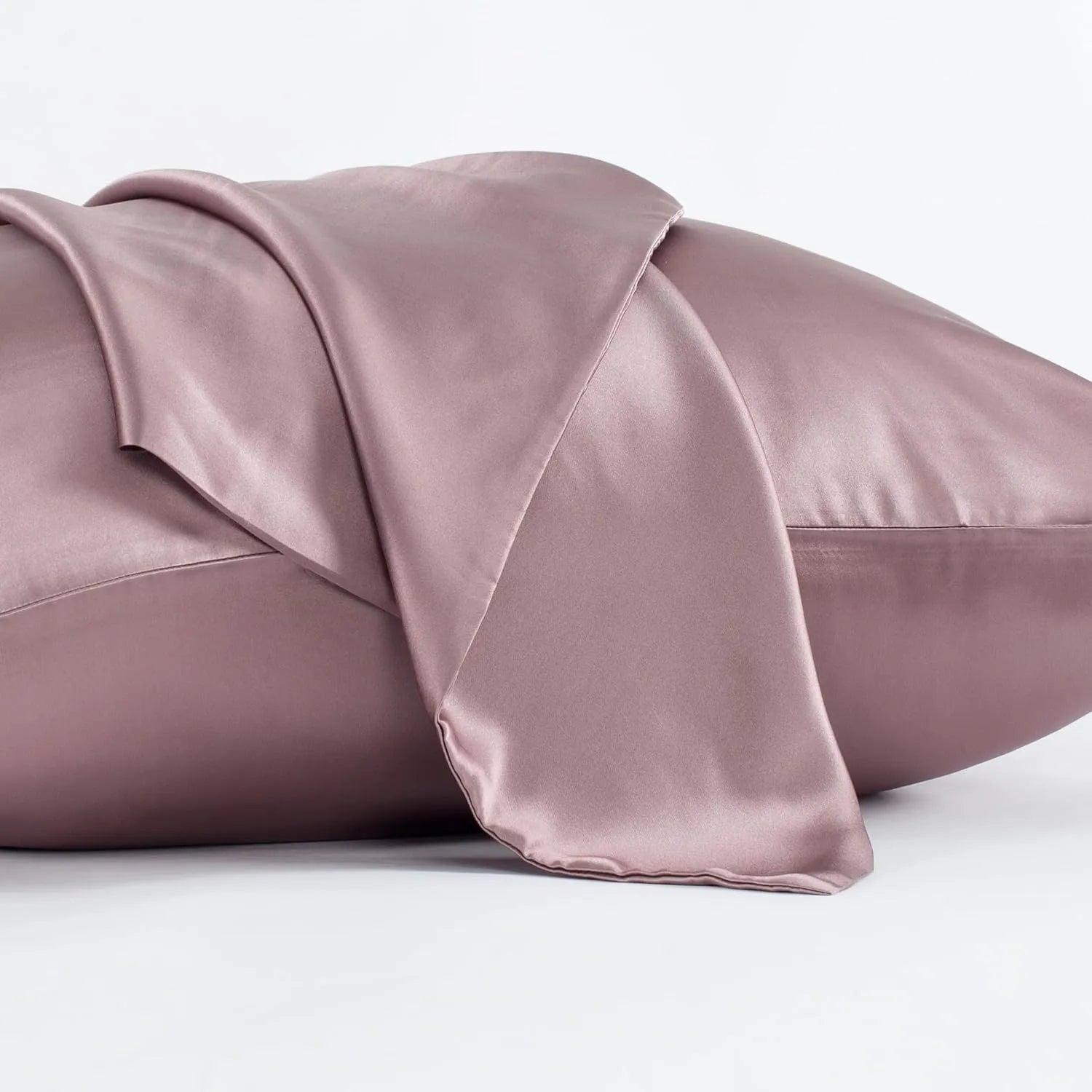 Dark gray 19 M silk envelope pillowcase with envelope closure on a bed.