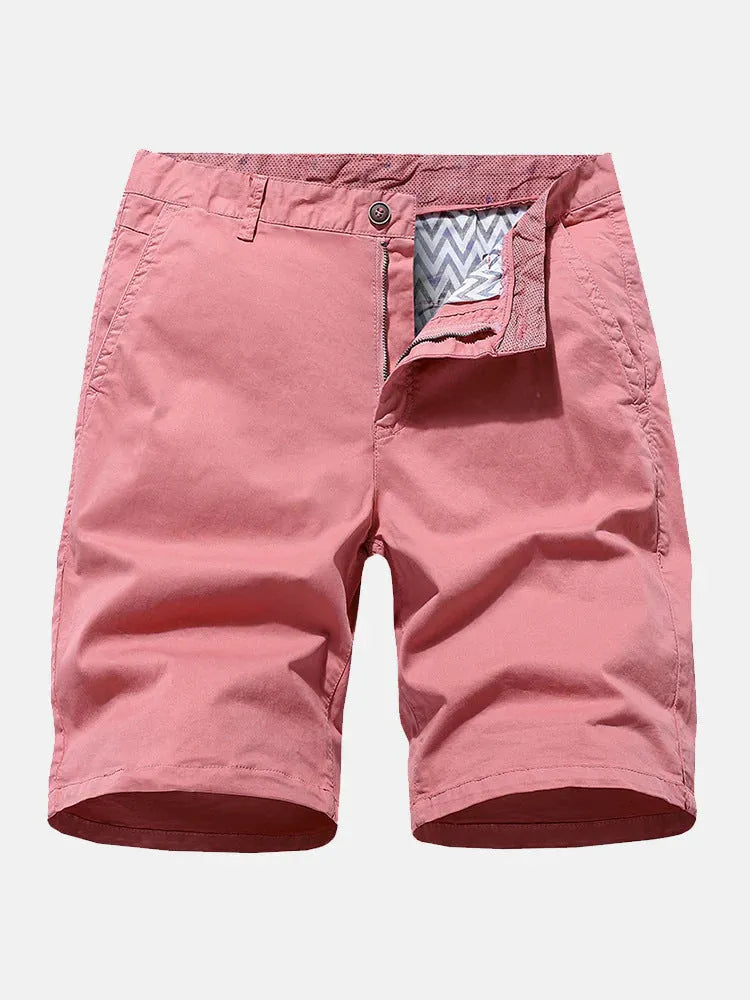 Men's loose fit printed denim shorts in blue, shown in a casual setting.