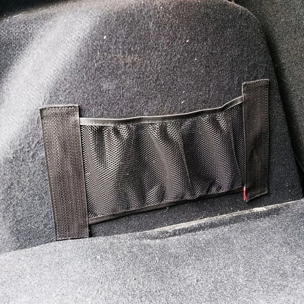 Elasticated grey polyester storage net stretched across a car boot, holding assorted items.