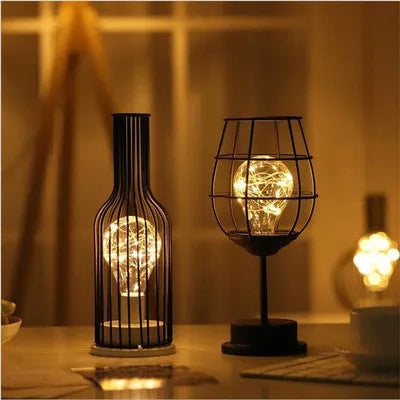 Minimalist hollow table lamp with wrought iron shell in red wine glass style emitting warm white LED light