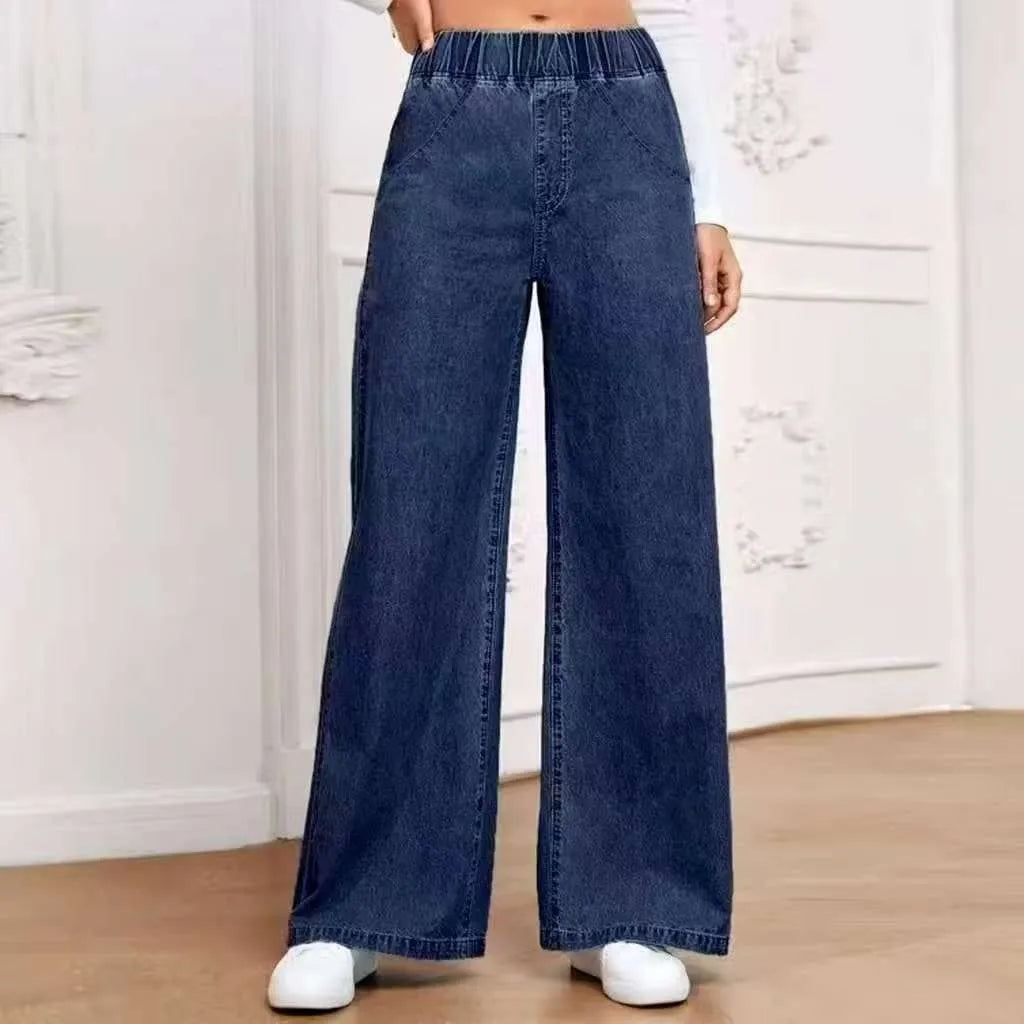 Light blue washed plus size wide-leg denim trousers laid flat showing straight leg silhouette