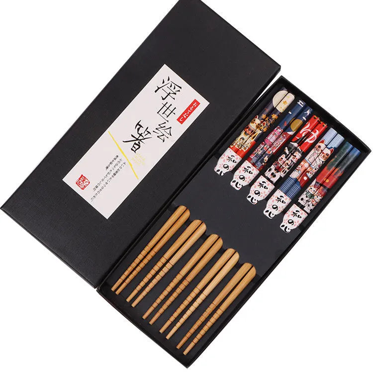 Set of five pairs of bamboo chopsticks with colourful lucky cat cartoon pattern.