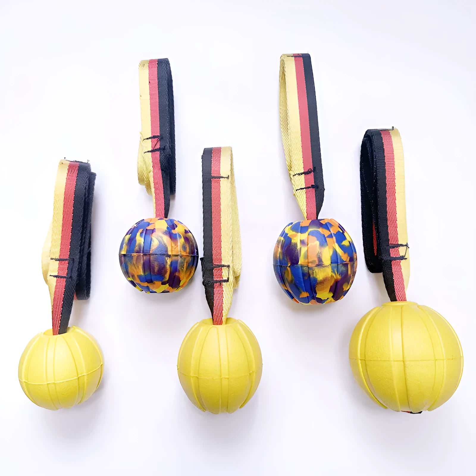 A floating EVA foam dog tetherball with a string attached, shown in camouflage colour next to a yellow one.