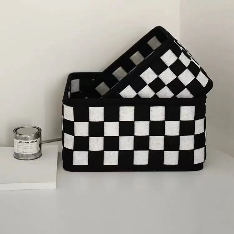 Checkerboard patterned foldable felt storage basket showing its woven texture and open-top design.
