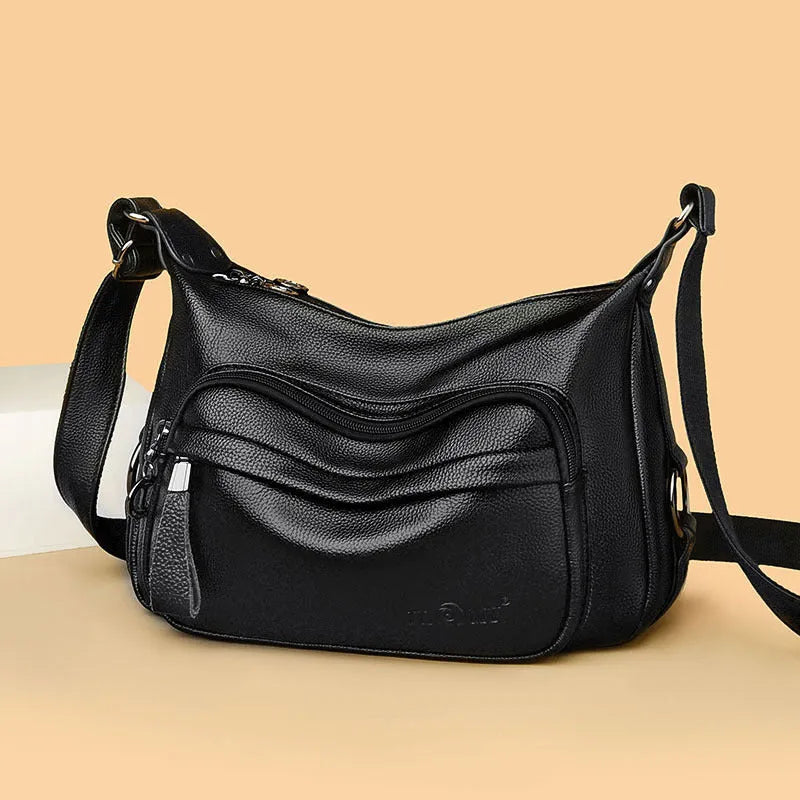 Blue women's large shoulder bag with crossbody strap showing internal mobile phone and certificate pockets