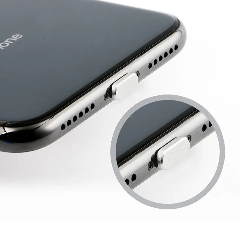 Aluminium alloy iPhone charging port dust plug in rose gold colour next to an iPhone.