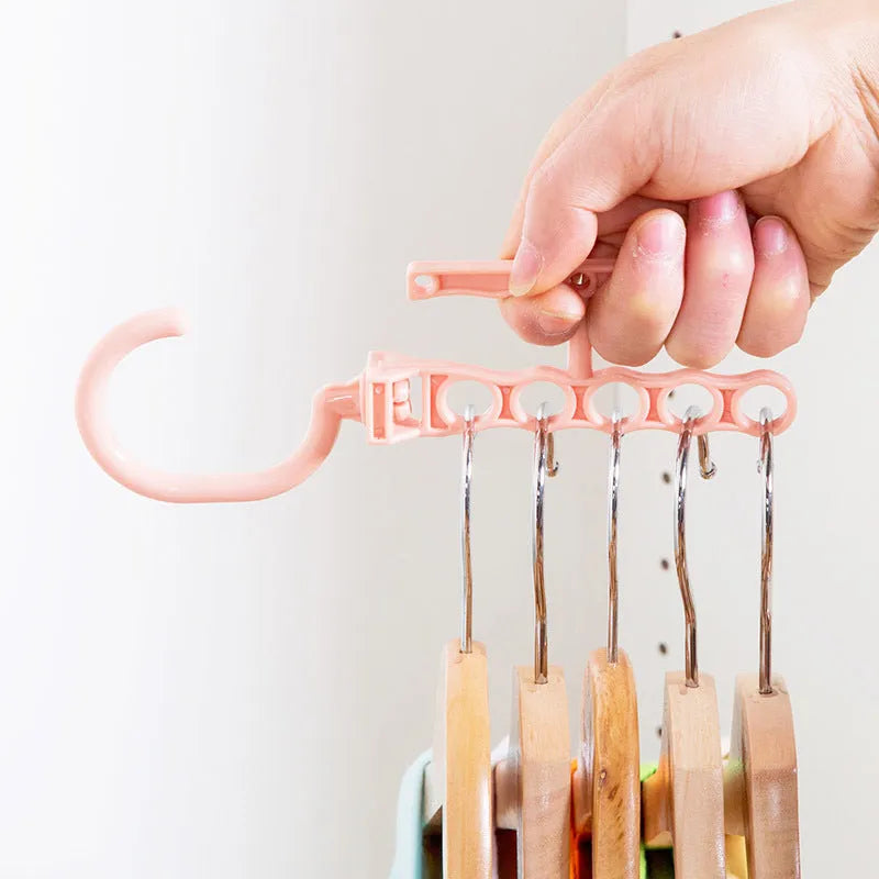 Blue revolving wardrobe hanger with five arms and a top handle on a white background