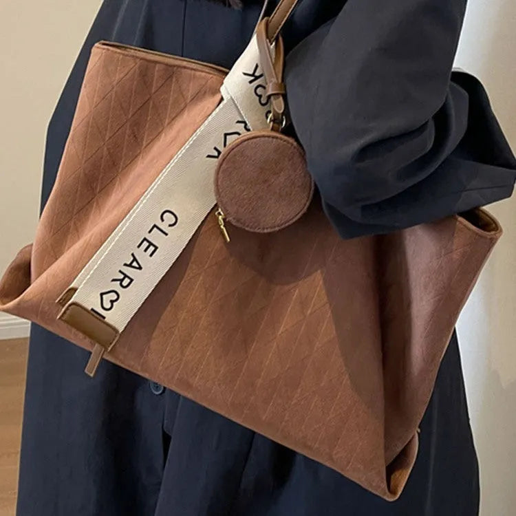 Large soft polyester shoulder bag in horizontal square shape with outer pocket, shown in light khaki colour.