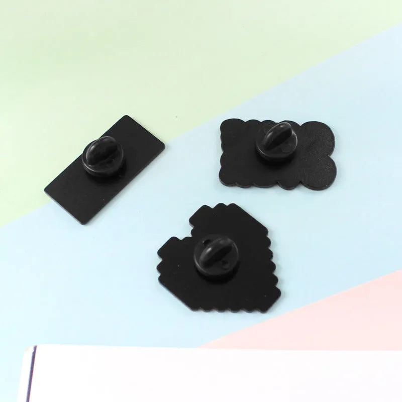 Stereo game console alloy pin badge in three colour options CC1122 CC1123 CC1124 on white background