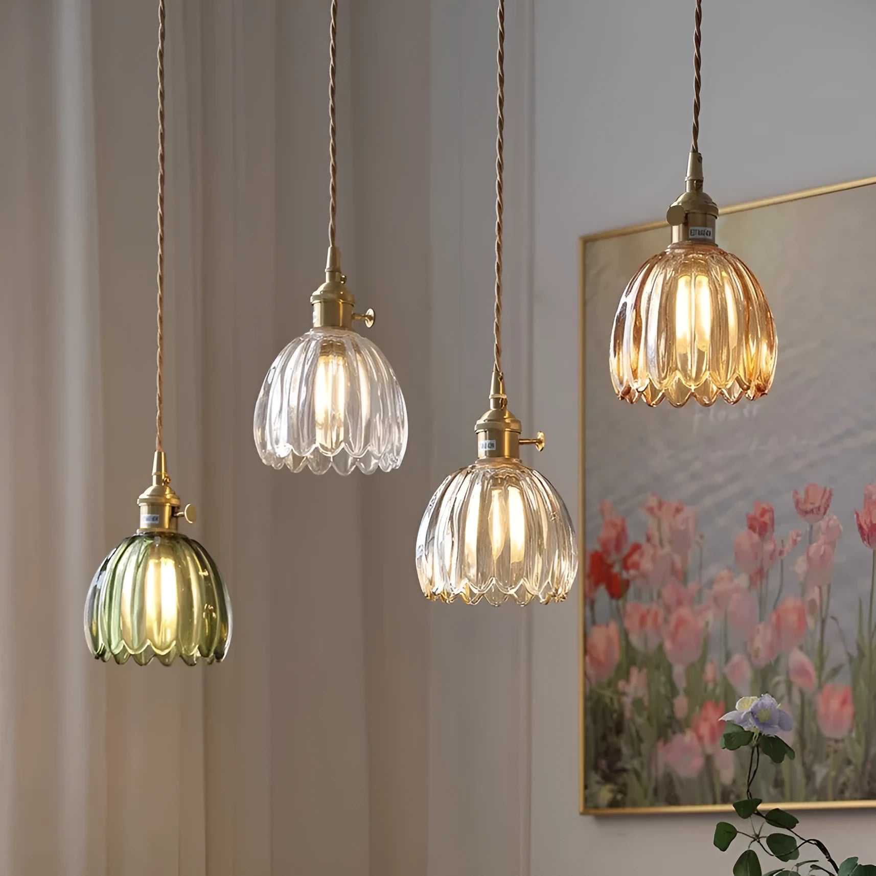 Nordic style bedside chandelier with a glass flower shade in amber, on a white background.