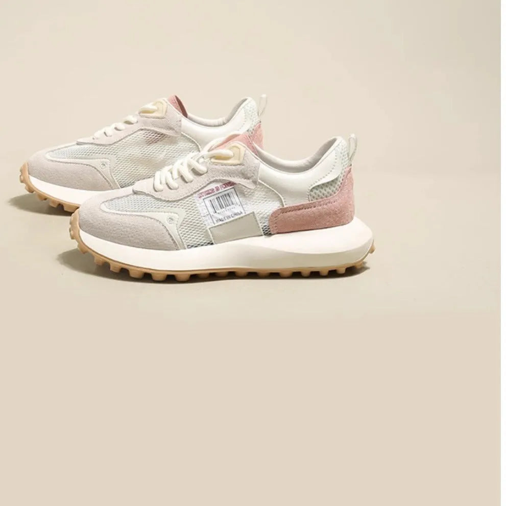 Women's grey retro low-top sneaker with round toe and flat rubber sole on a neutral background.