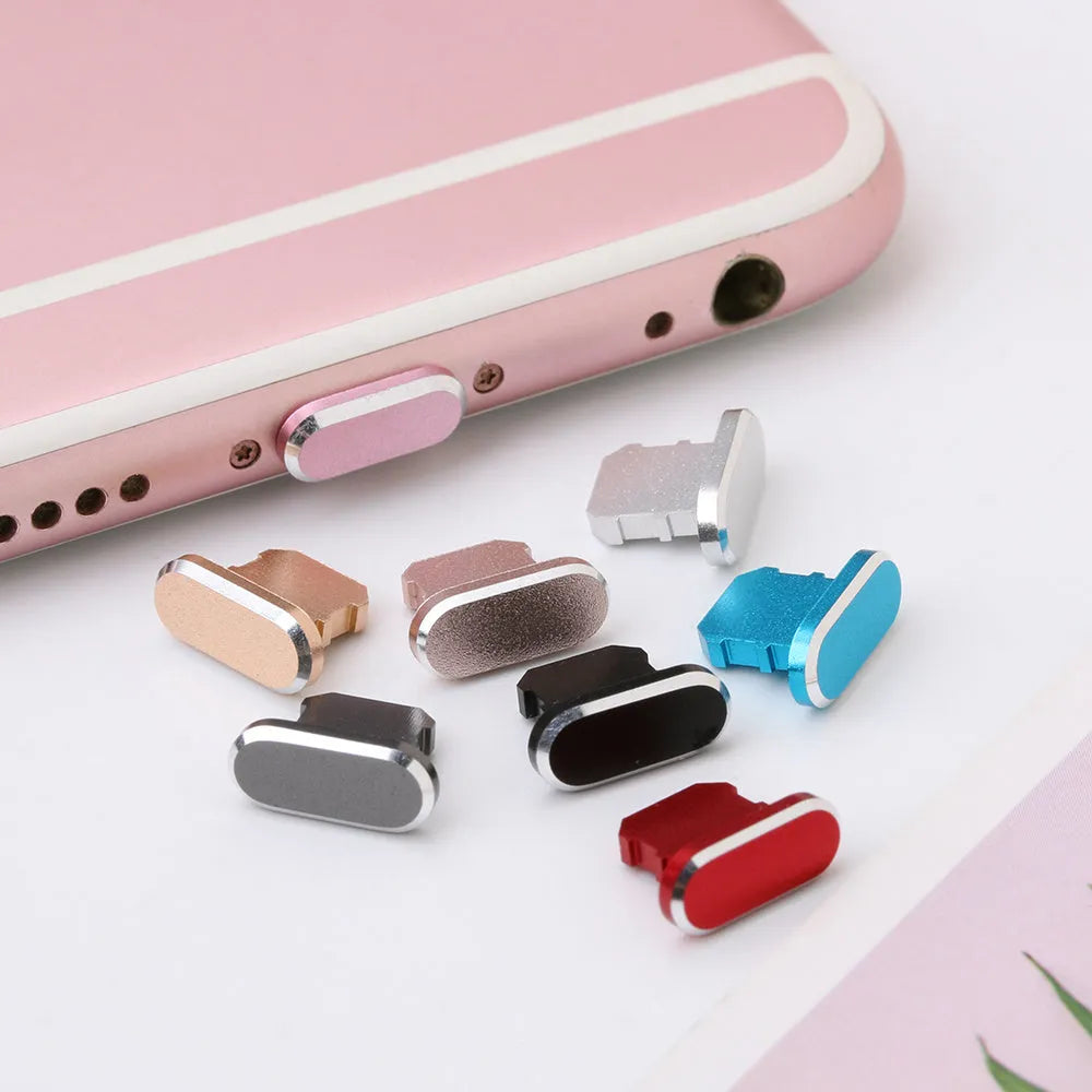 Aluminium alloy iPhone charging port dust plug in rose gold colour next to an iPhone.