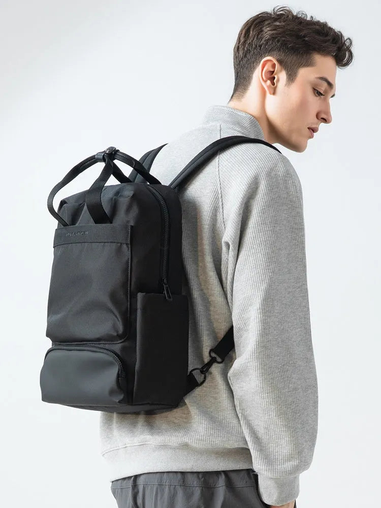 Black Oxford cloth computer backpack showing laptop compartment and storage organisation