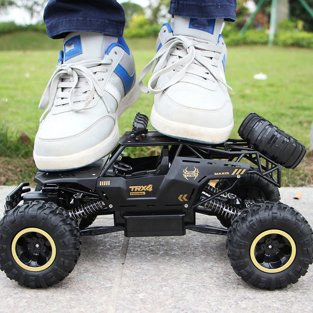 Large black 2.4G remote control four-wheel drive off-road climbing car on rough terrain