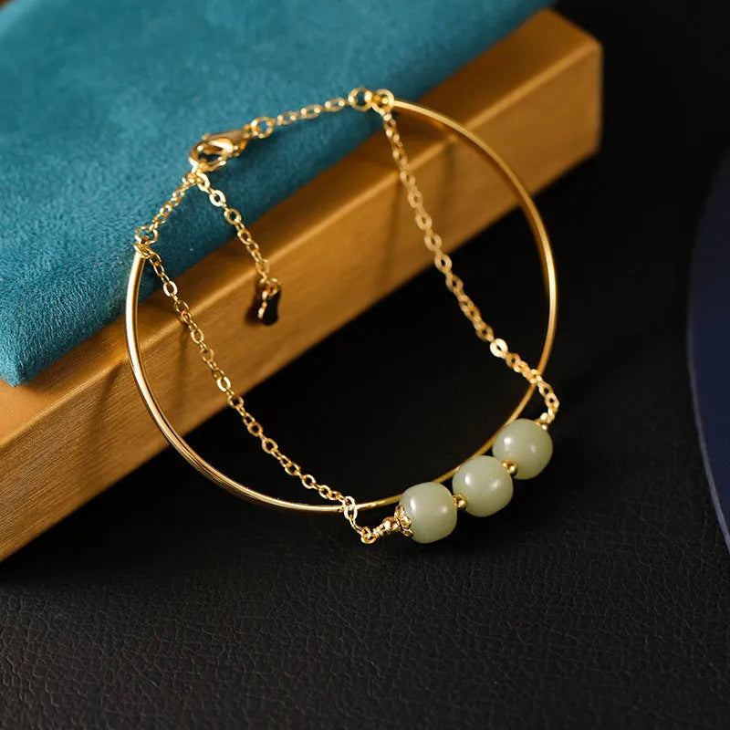 Hetian jade lucky beads bracelet with gold inlay, shown in women's fake two pieces style.