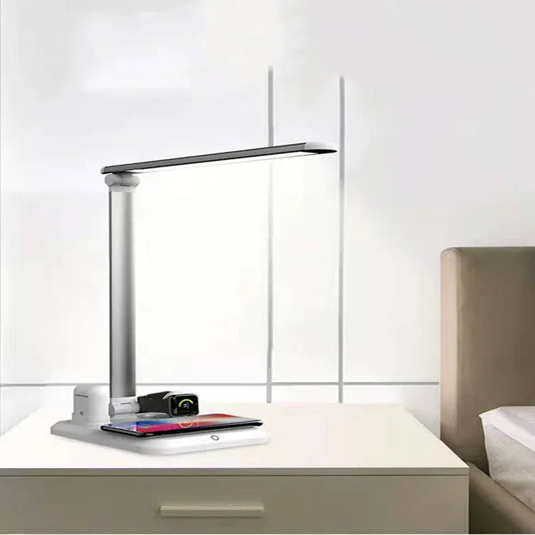 Black and white 4-in-1 LED desk lamp with wireless charging pad showing USB-C port