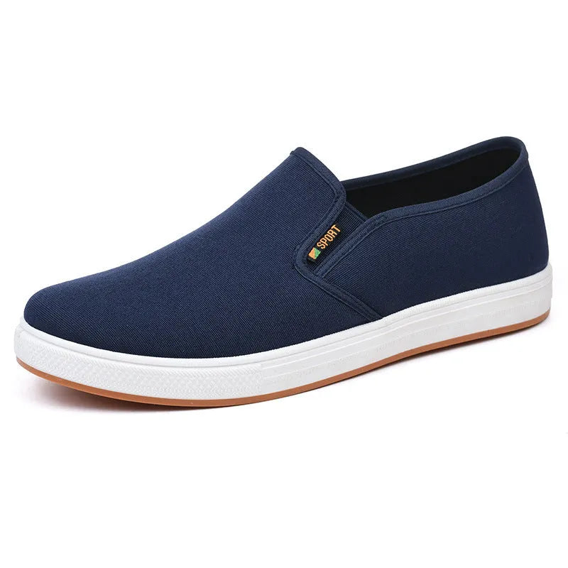 Men's low-top canvas slip-on shoes in blue colour showing round-toe design and composite soles