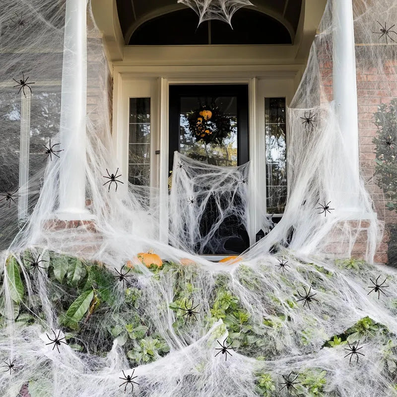 White cotton spider web Halloween decorations with spiders on dark background