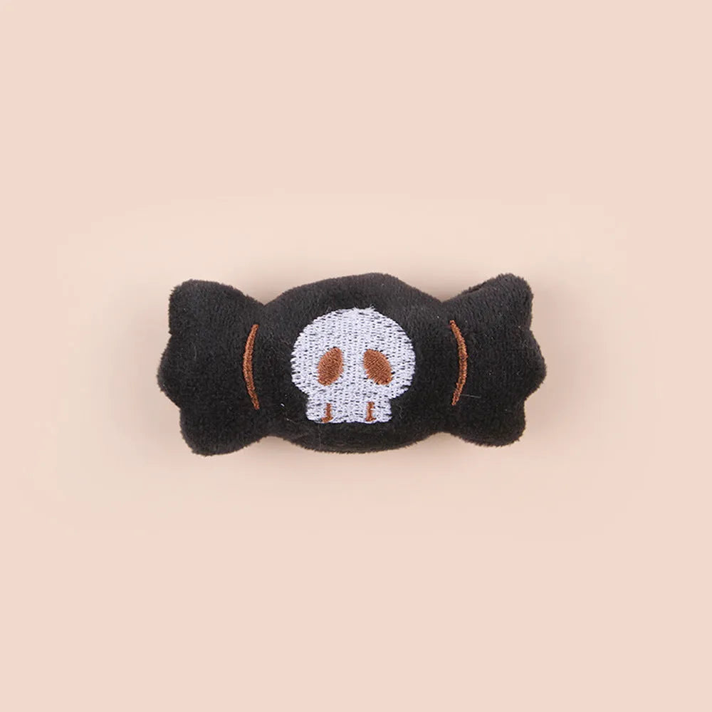 Plush cat teaser toy with long wand handle showing candy and skull designs