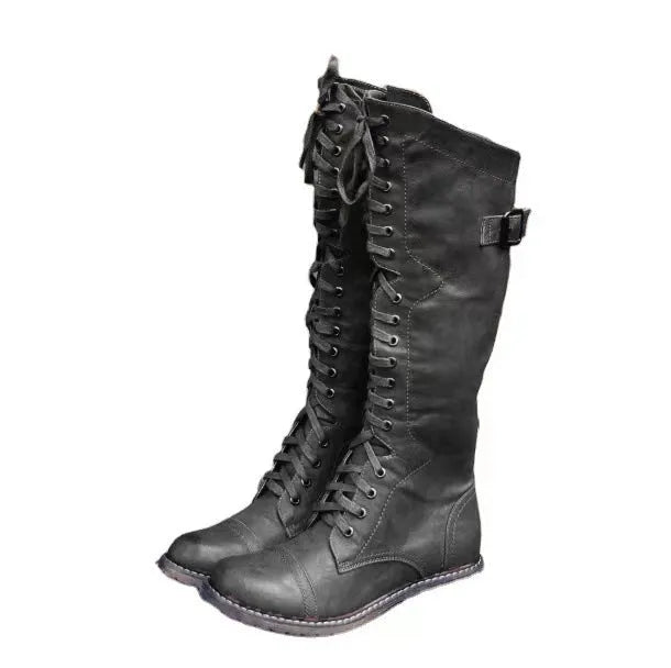 Women's black chunky heel high leg ankle boot with round toe and low rubber sole.