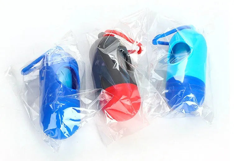 Roll of coloured dog waste bags showing black, blue, green, pink, and purple options.
