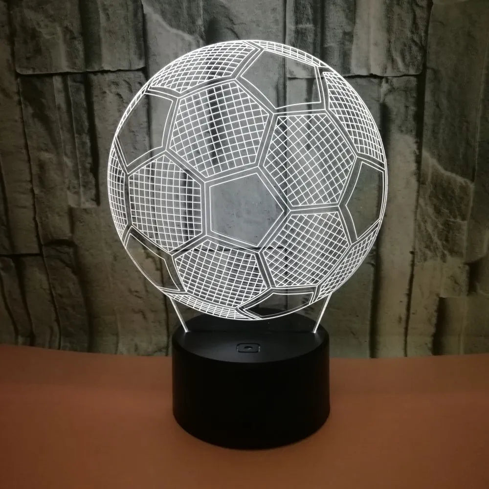 3D acrylic football night light on a square black base, showing multi-coloured LED illumination.
