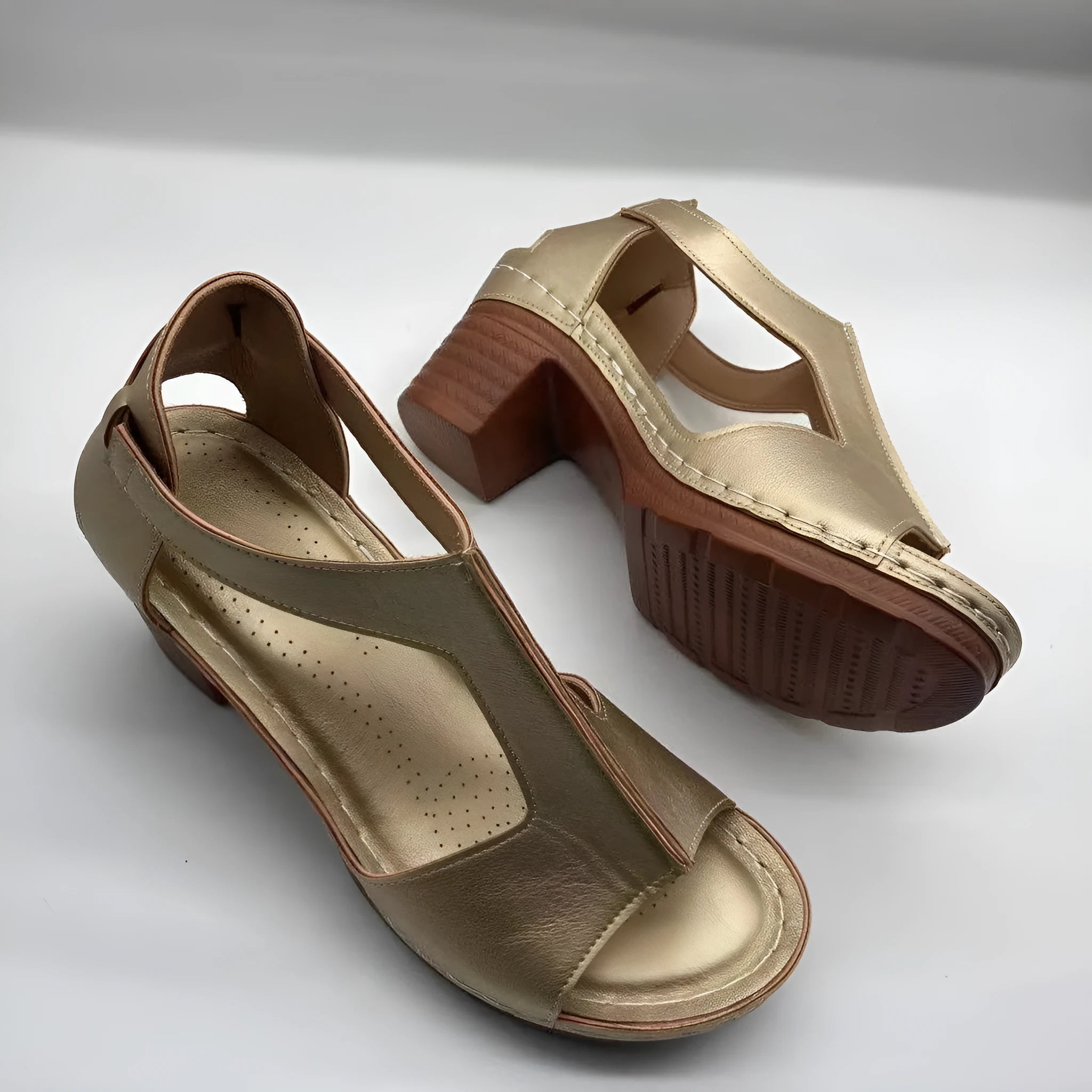 Women's white peep toe wedge sandals with a Roman-style buckle strap and low heel.