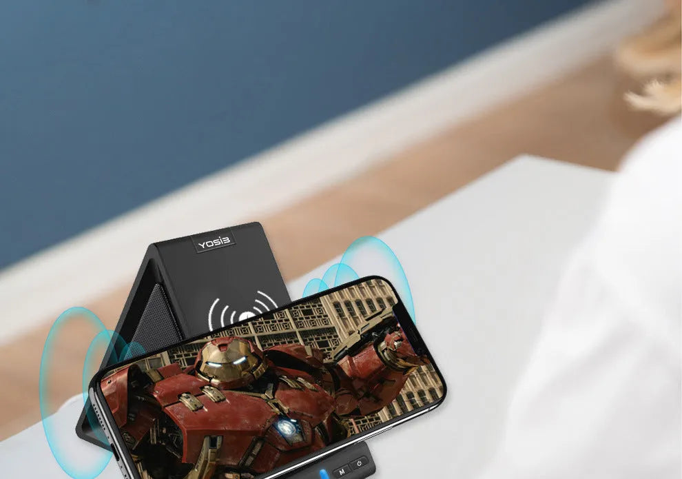 Black multifunctional Bluetooth speaker with integrated mobile phone stand and wireless charging capability