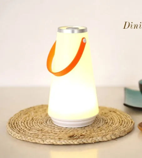 White rechargeable LED night light lantern on bedside table measuring 12x12x22cm with warm light