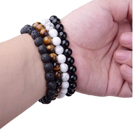 Women's black onyx agate beaded bracelet with geometric design and elastic cord.