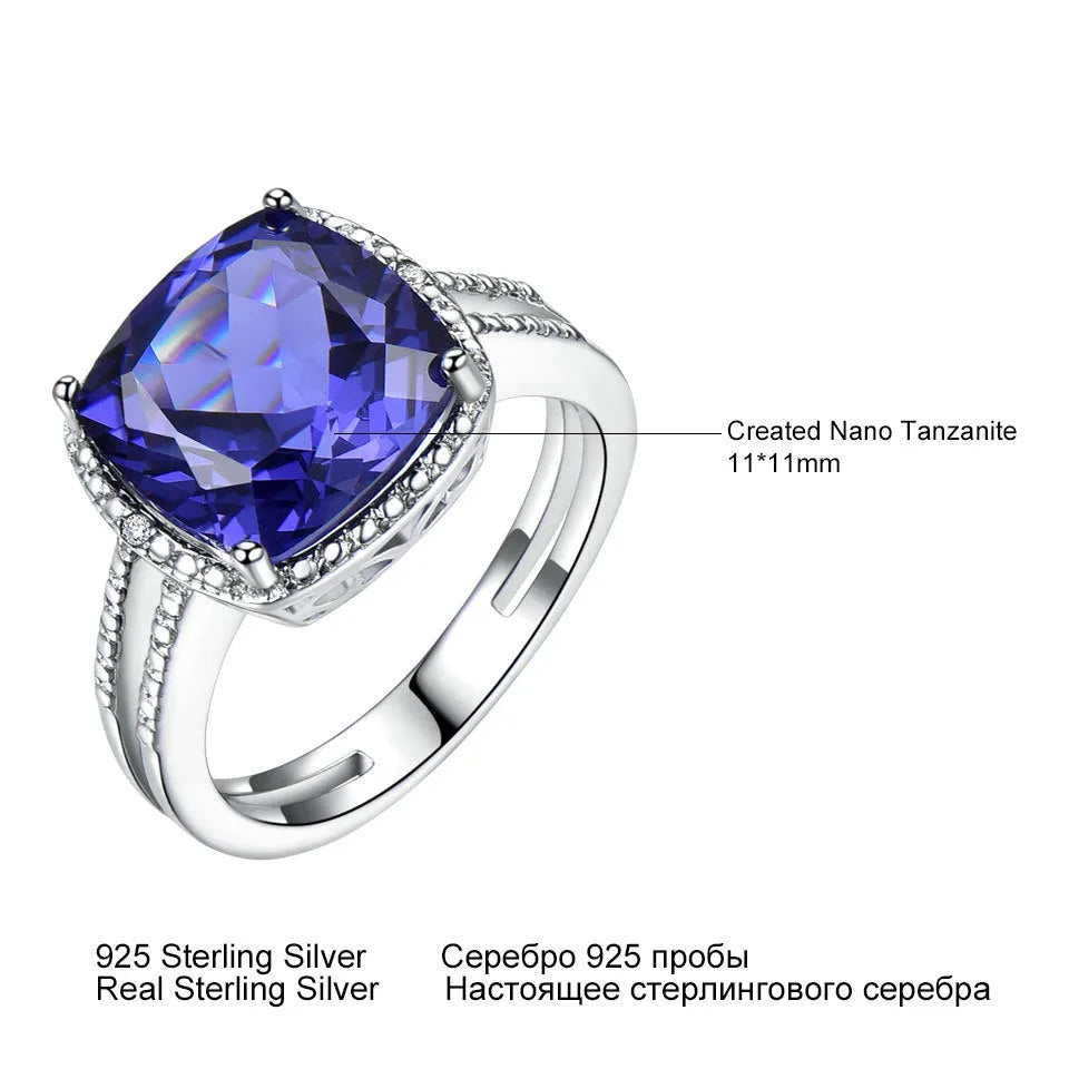 Blue tanzanite gemstone set in a sterling silver women's ring on a grey background