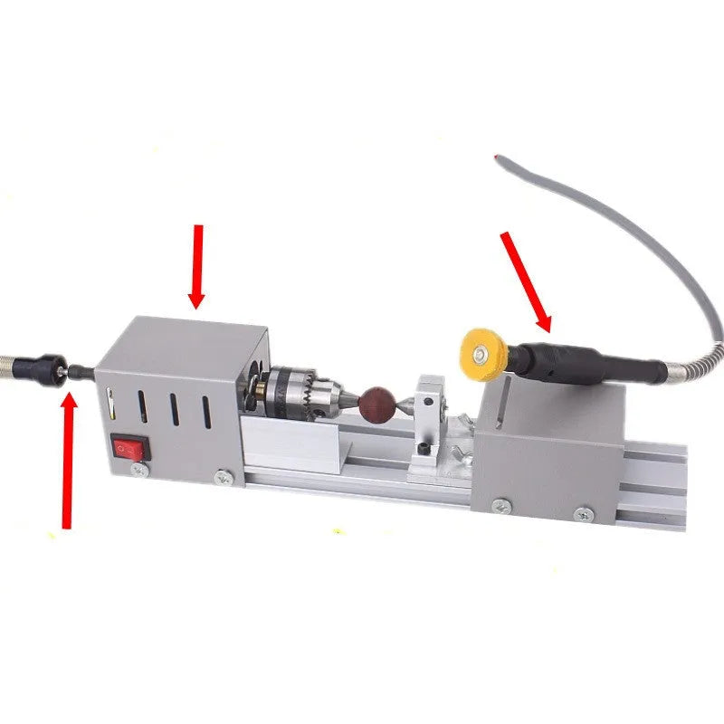 Mini silver metal woodworking lathe with carving knives on benchtop