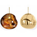 Nordic post-modern lava lamp chandelier with glass body and metallic finish in bedroom setting