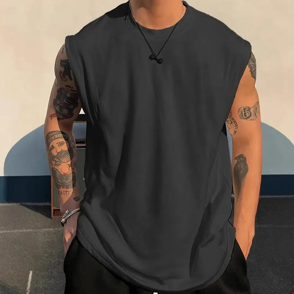 A man's loose grey cotton sleeveless t-shirt on a hanger, showing the straight hem and pullover design.