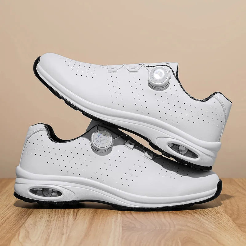 Black and white low top mesh tennis shoes with a round toe and flat composite sole on a plain background.
