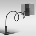 Black bedside phone mount with long flexible arm and saddle base holding a mobile phone.