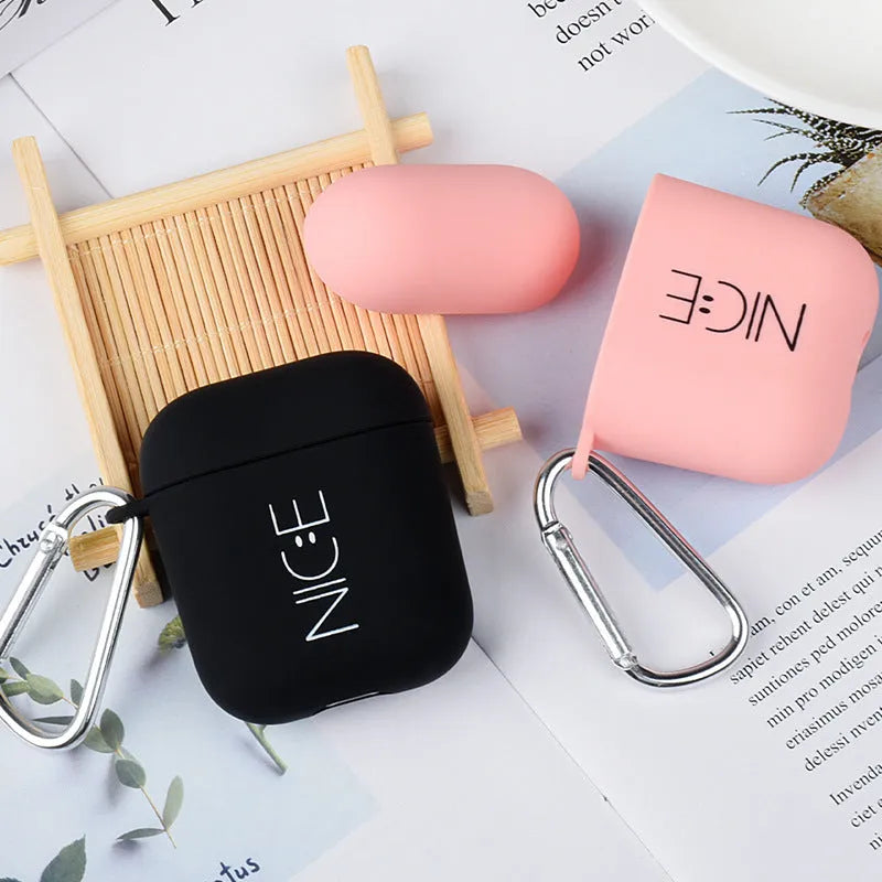 Black and pink AirPods case covers with smiley face and flower decorative motifs
