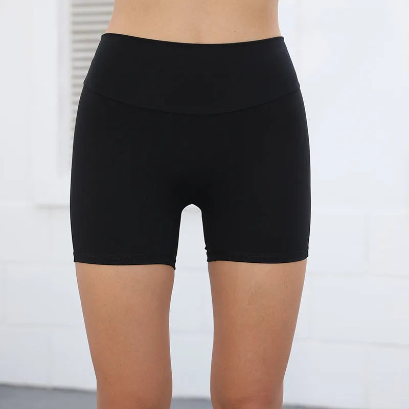 Women's high-waisted fitness shorts with pockets in quick-dry nylon fabric, shown in avocado green colour