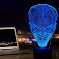 USB-powered 3D acrylic LED lamp showing seven colour options and remote control on a desk.