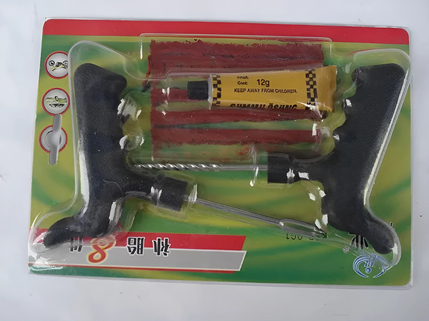 Black and yellow vacuum tyre repair tool kit with probe, pin, glue, and rubber strips on plastic packaging.