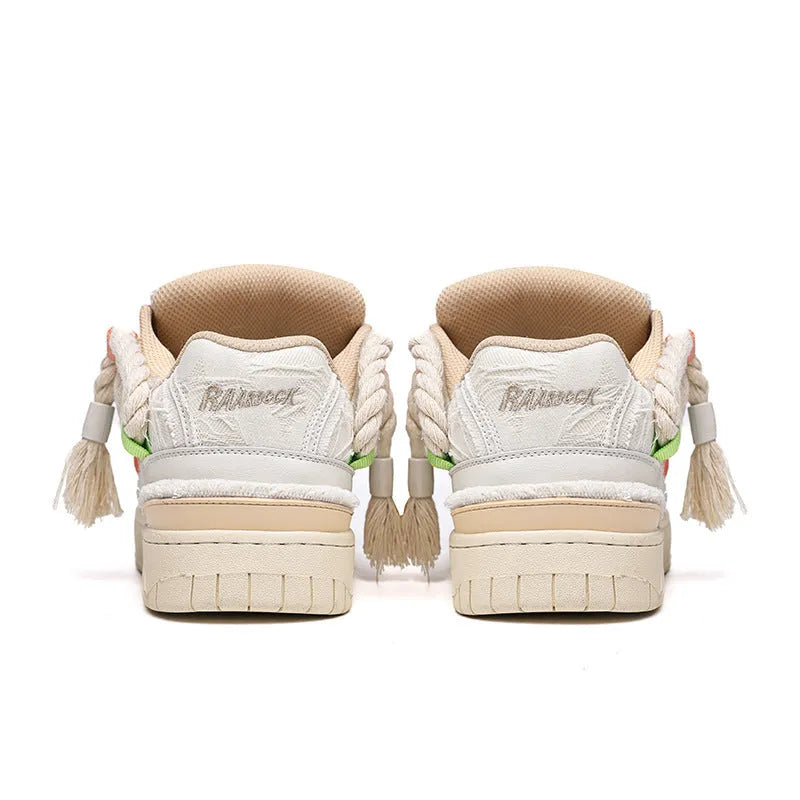 Cream coloured retro lace-up low-top skate shoes on a white background.