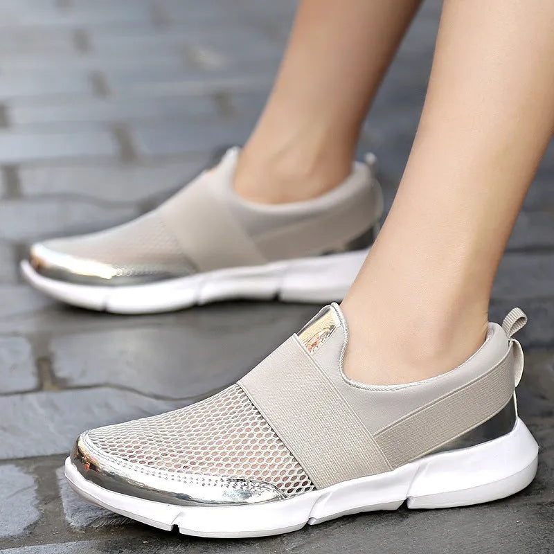 Women's blue low-top casual sneakers with mesh inside on a hard floor surface