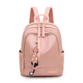 Black women's casual nylon backpack with soft handle and shoulder straps showing internal compartments
