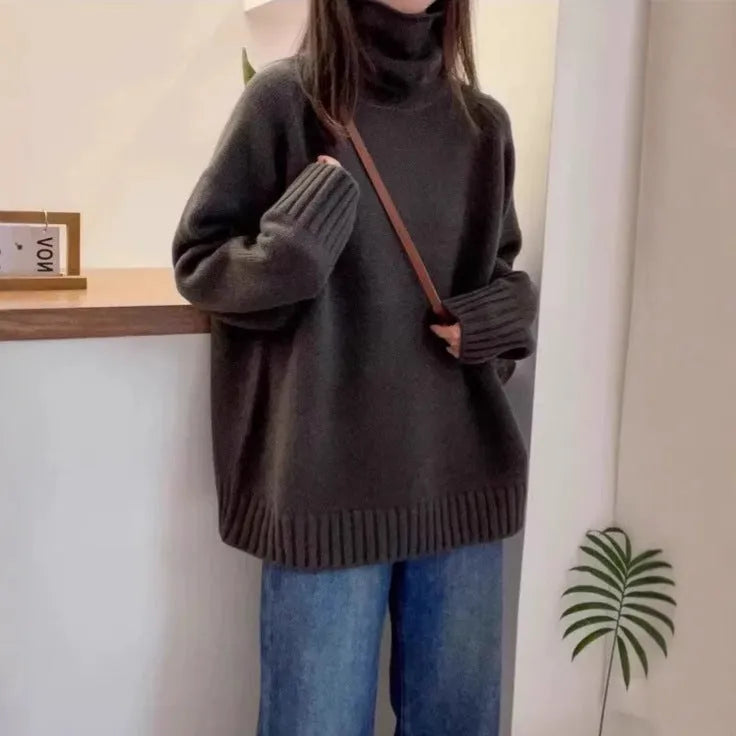 Women's loose turtleneck sweater with thick curling pile collar in red, camel, grey, or black.