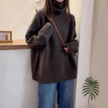 Women's loose turtleneck sweater with thick curling pile collar in red, camel, grey, or black.
