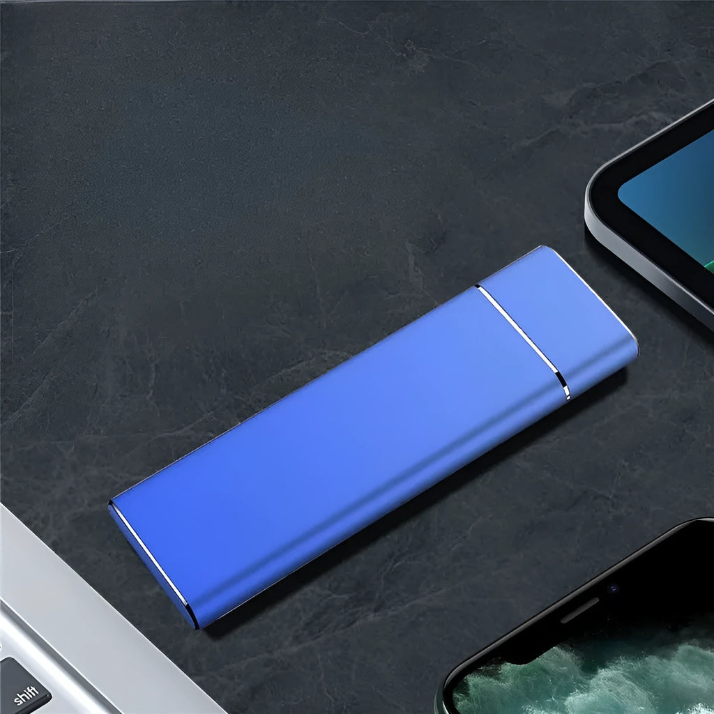 Sapphire blue portable external solid state hard drive with metal shell, shown next to its USB cable.