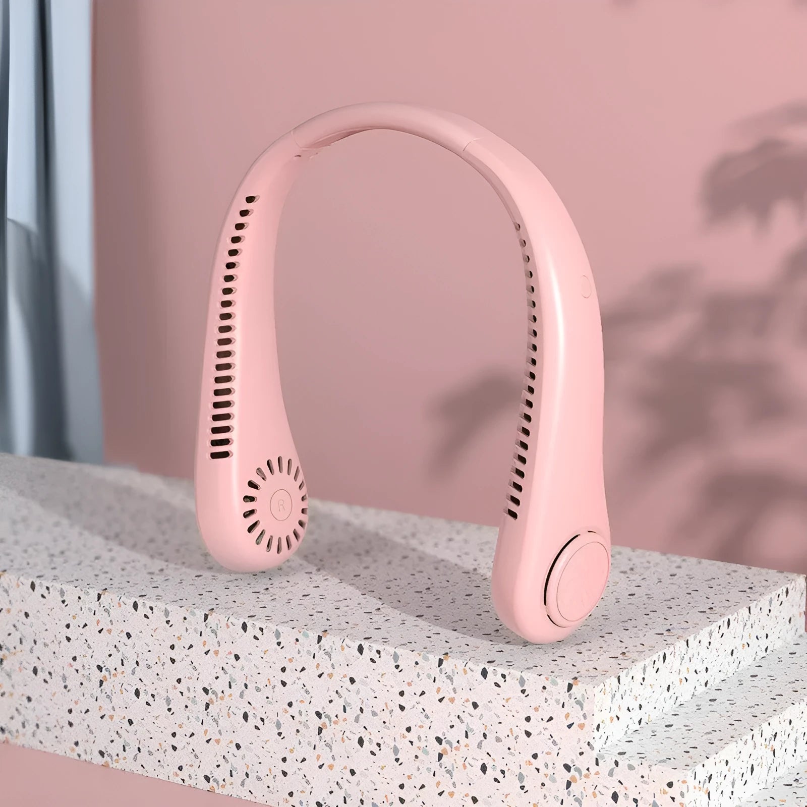 Pink USB rechargeable bladeless neck fan worn around neck, showing flexible band and air vents.