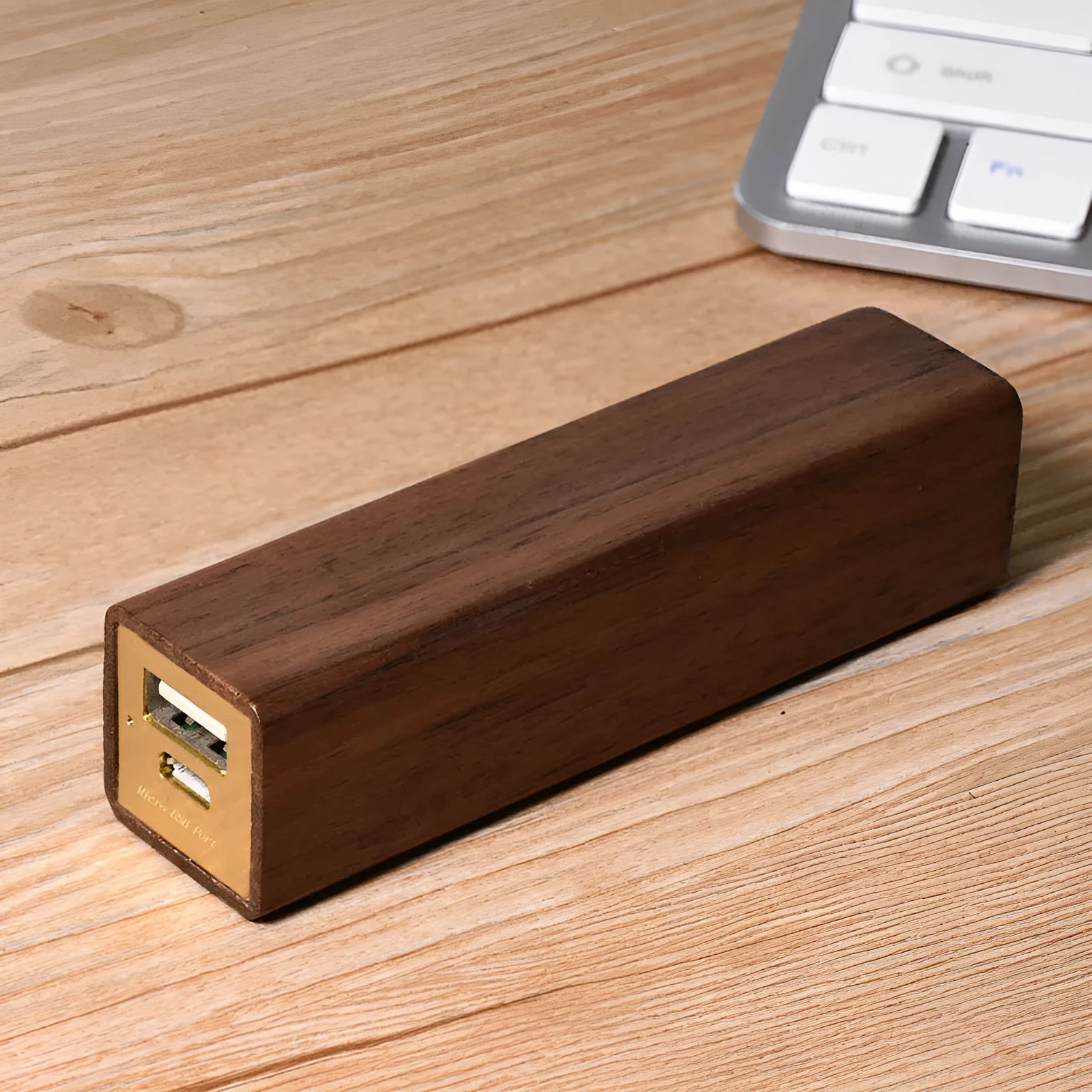 Portable black walnut solid wood power bank with 2000mAh 18650 battery, 100mm length, brown colour, on light background