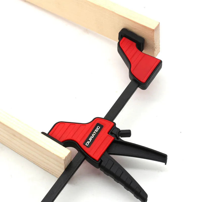 Black plastic woodworking clamp with soft rubber grip and quick regression key, available in multiple sizes