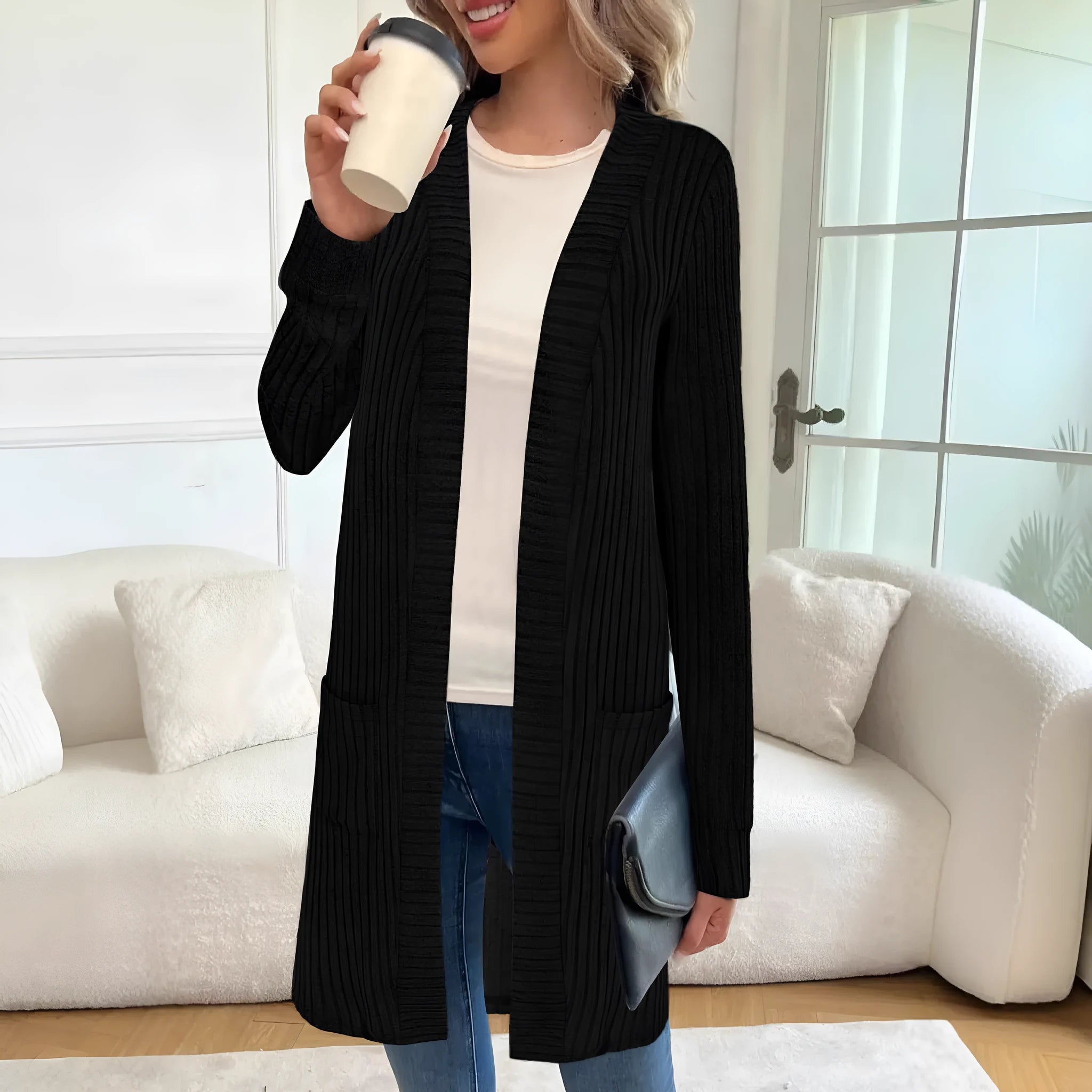 Black oversized knitted cardigan jacket with long sleeves and loose pockets.